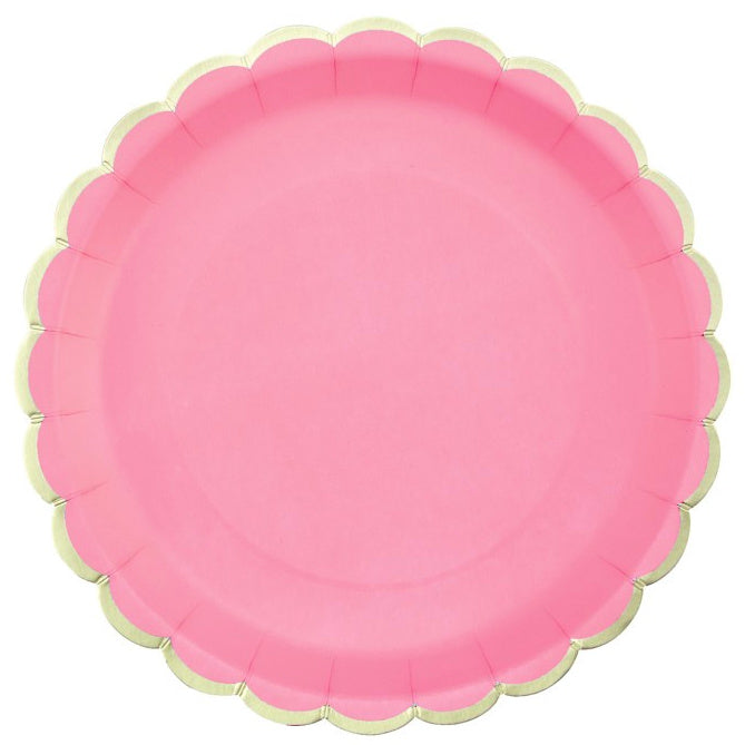 Pink paper plate with scalloped edge on a white background