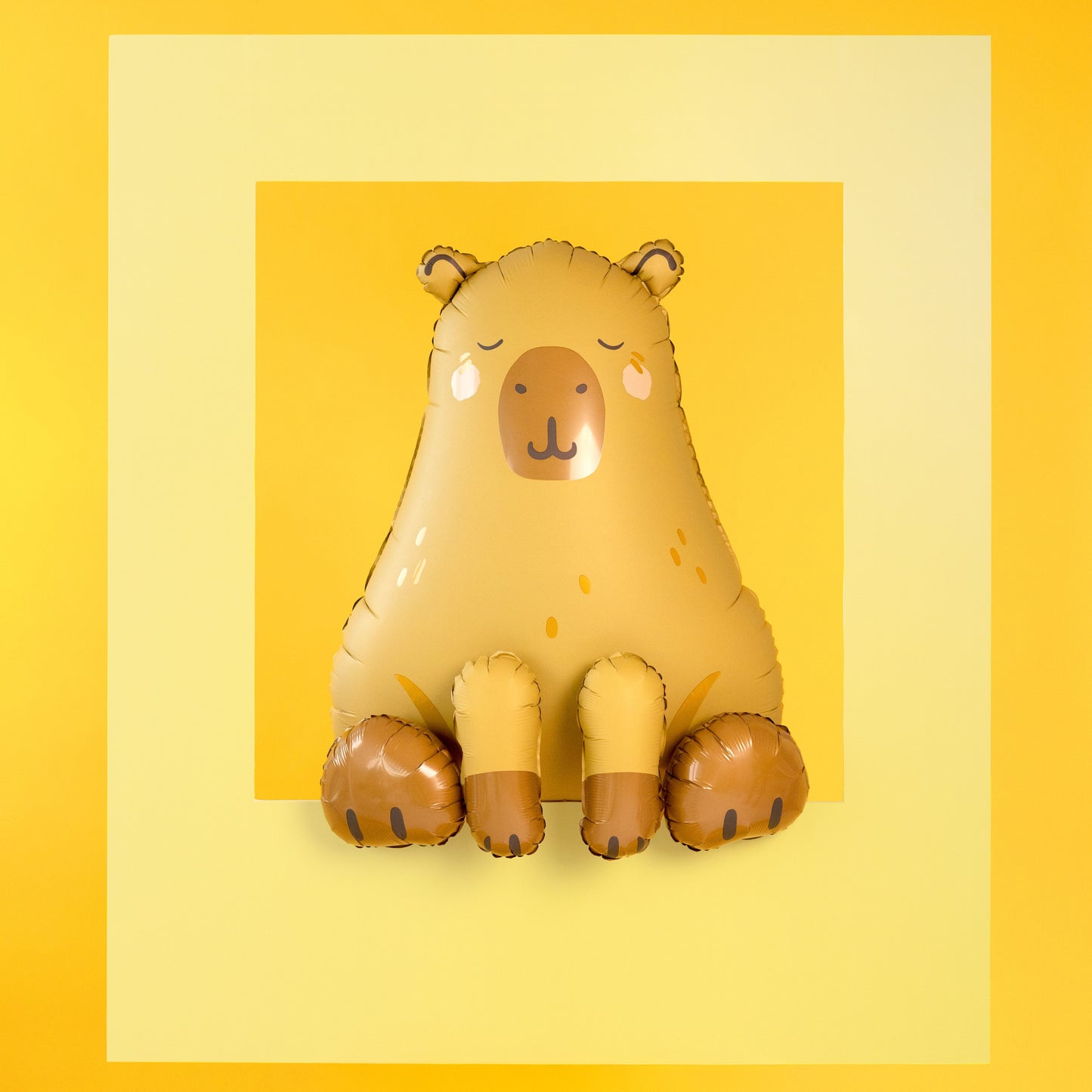 Capybara shaped foil balloon in beige and brown sitting upright