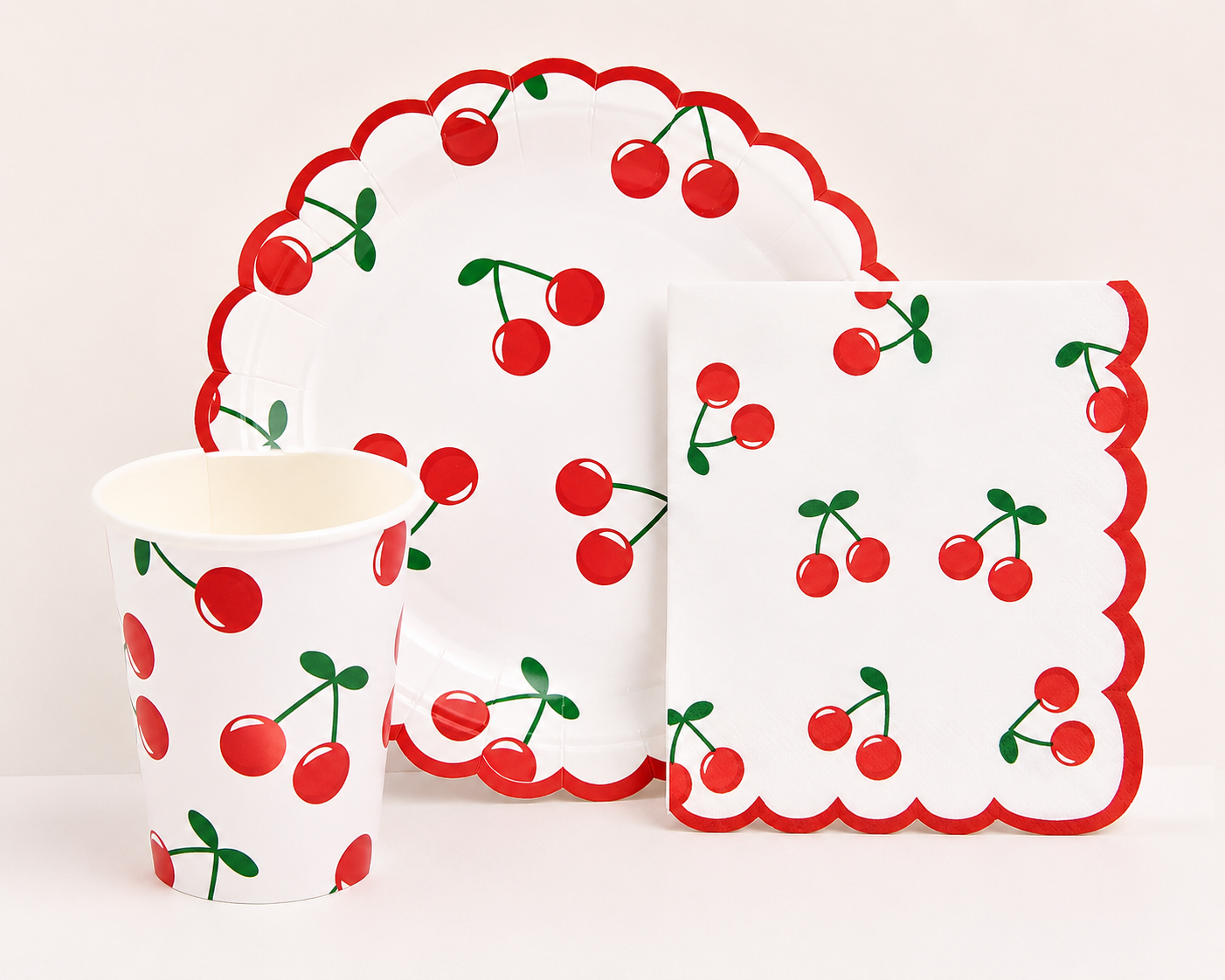 Fun cherry print party tableware with a bold red scalloped edge.