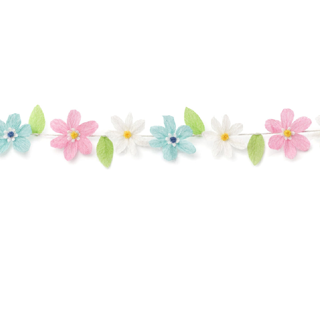Pastel crepe paper flower garland with pink, white and turquoise flowers and green leaves on a white string, spring and Easter party decoration.