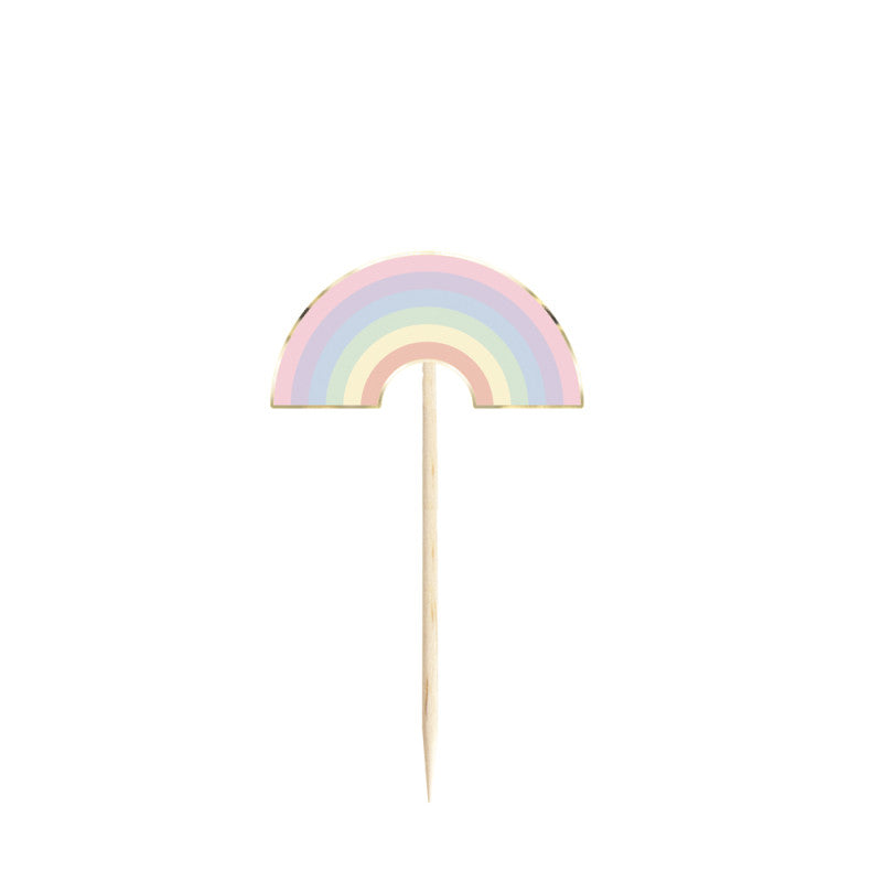 Pastel rainbow-shaped cake topper on a white background