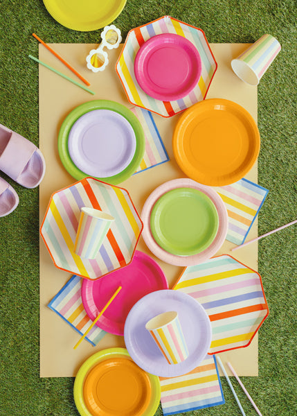 A summer picnic party setup with summer themed tableware and party supplies
