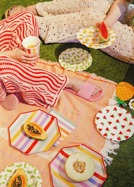 A summer picnic party setup with summer themed tableware and party supplies