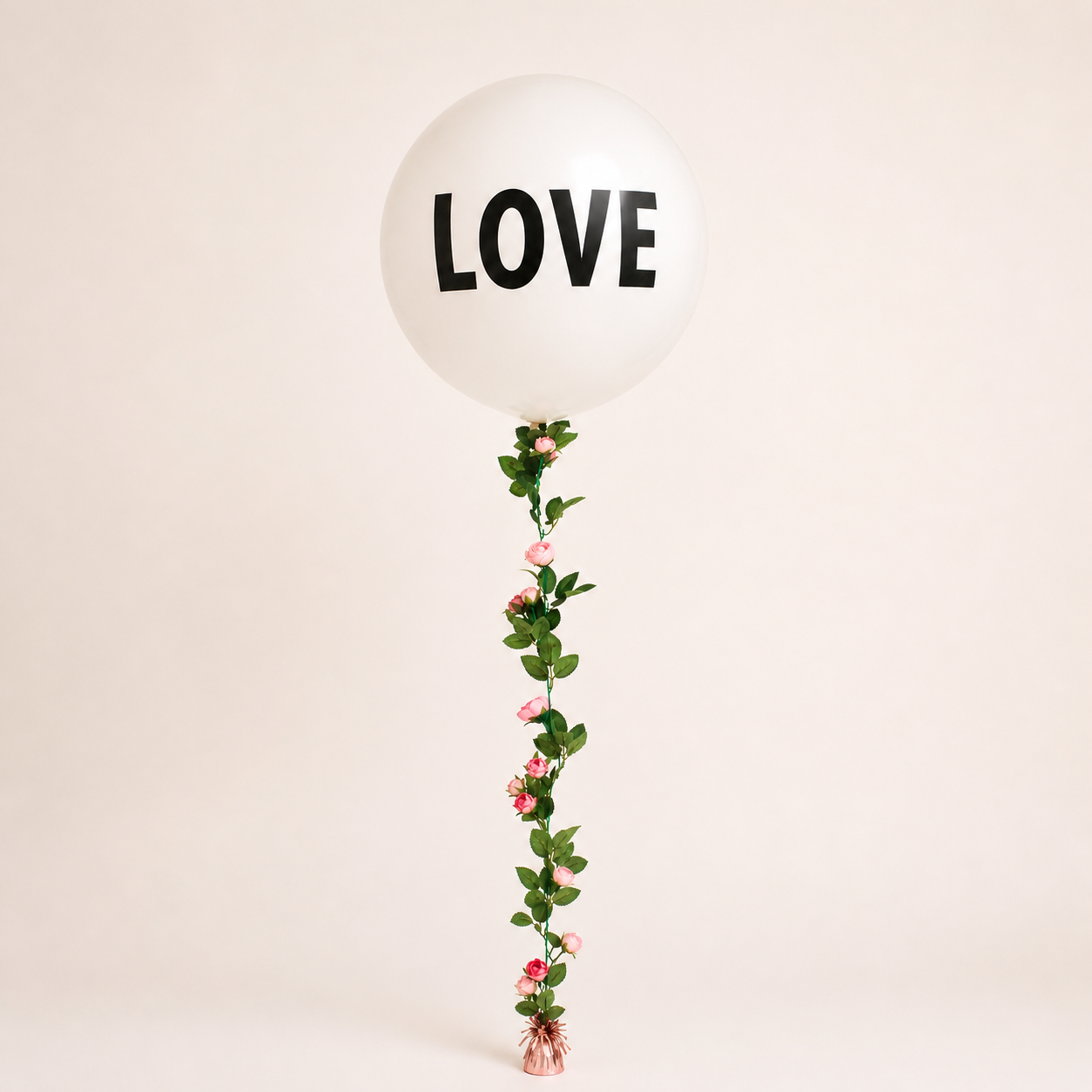 A large latex balloon with Love Text and a rose garland balloon tail