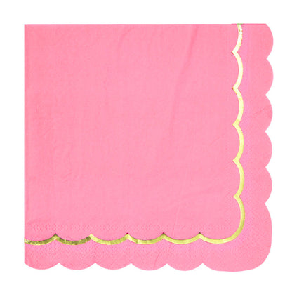 Pink napkin with gold scalloped edge on a white background