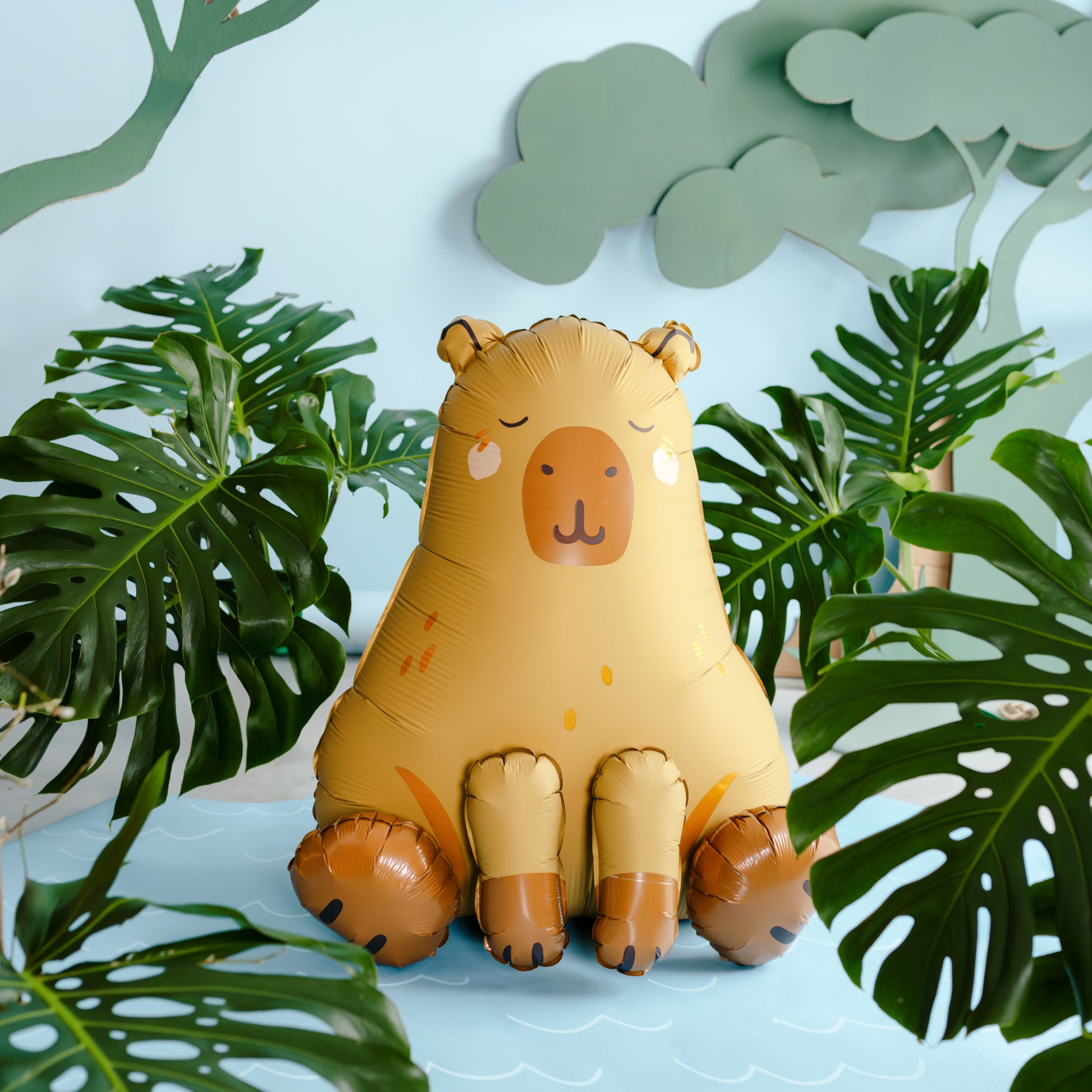 Capybara shaped foil balloon in beige and brown sitting upright
