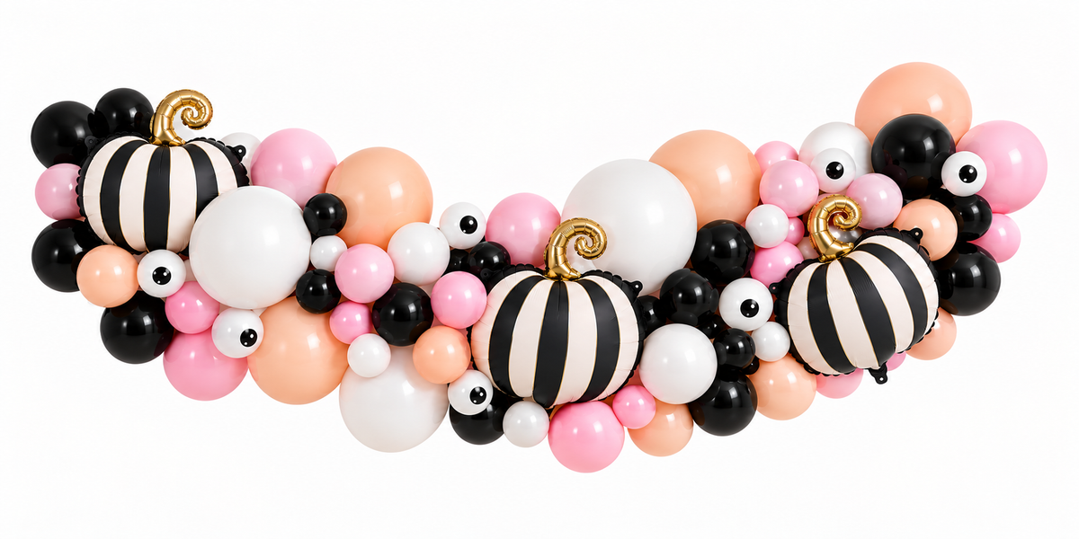 Pink, peach, black and white Halloween balloon garland with striped pumpkin balloons and eyeball balloons