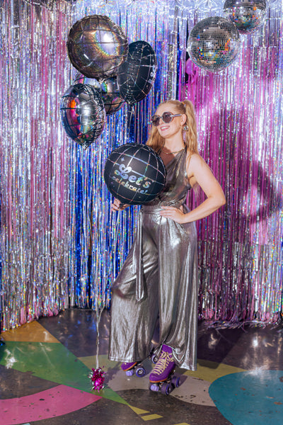 Set of five silver, holographic and black disco ball foil balloons including Let's Celebrate balloons.