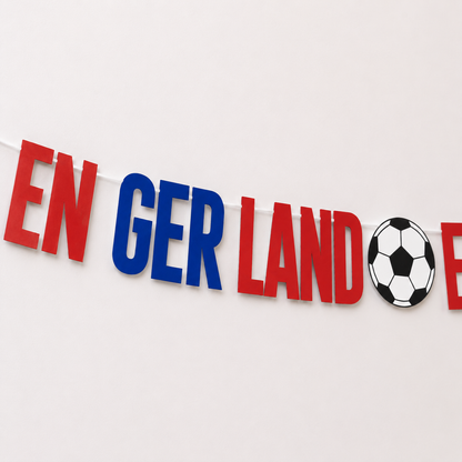 Decorative banner with 'EN GER LAND' and a football on a white background