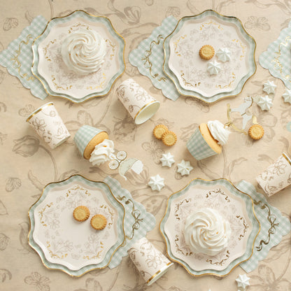 Decorative plates with swirl designs and small cookies on a beige patterned background