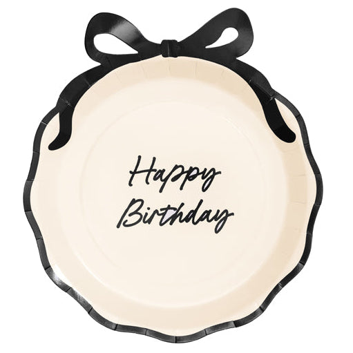 Round decorative plate with 'Happy Birthday' text and a black bow on a white background