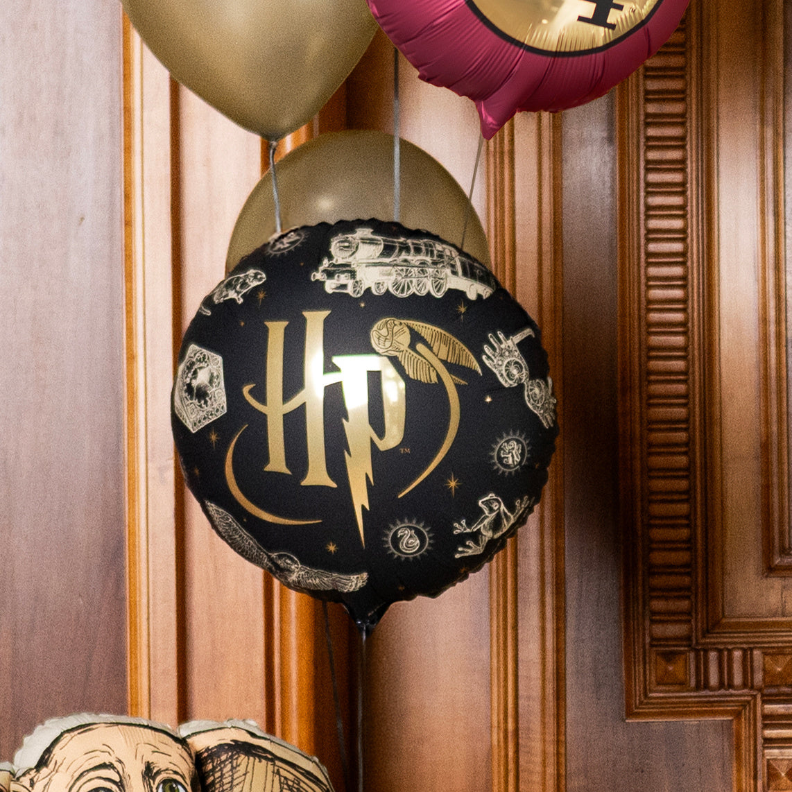 Harry Potter black and gold foil balloon at a birthday party