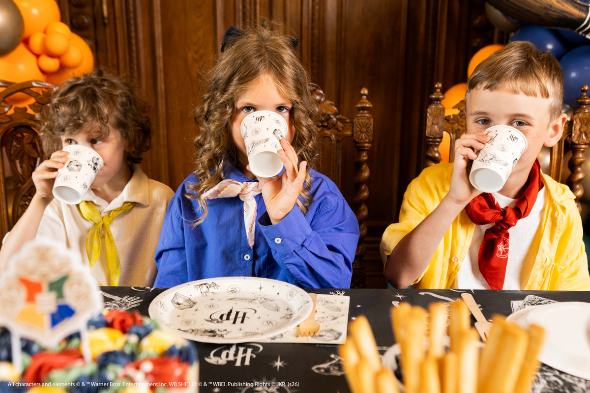 Children enjoying a Harry Potter themed party with Hogwarts paper cups
