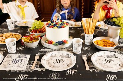 Harry Potter party table with Hogwarts paper cups, plates and decorations