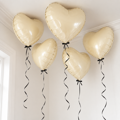 Ivory Heart Foil Balloons with Black Bows and Ribbons floating at the ceiling