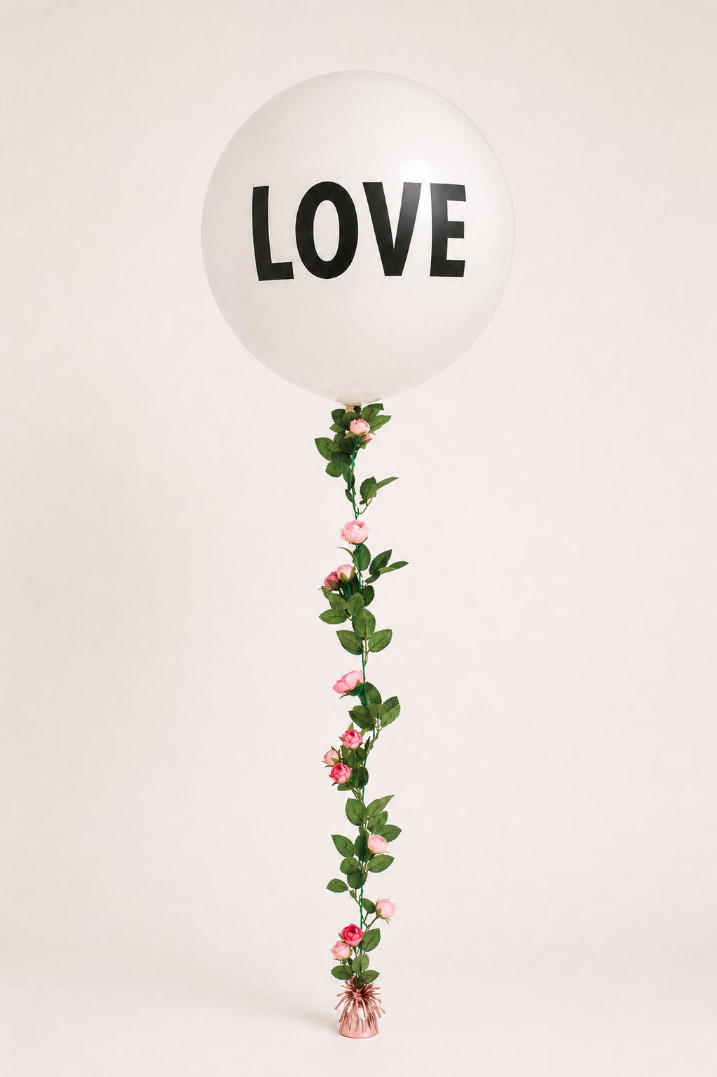 A large latex balloon with Love Text and a rose garland balloon tail