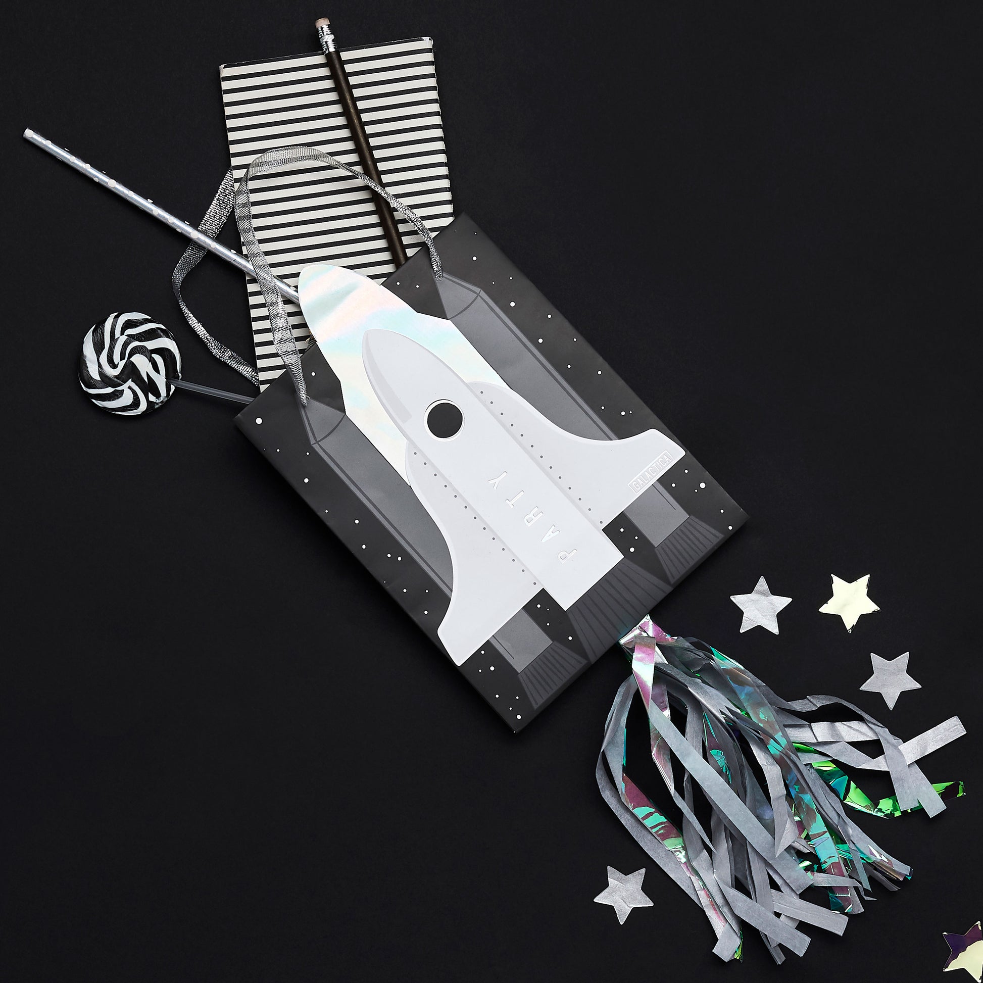 Luxury space themed party bags with rocket embellishments, ribbon handles and colourful streamers