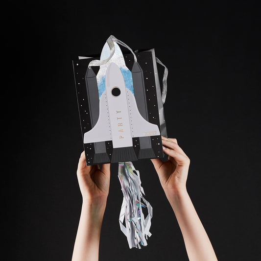Luxury space themed party bags with rocket embellishments, ribbon handles and colourful streamers