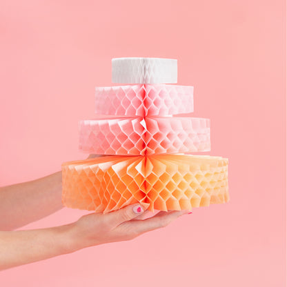 Pastel honeycomb paper cake decoration used as party table centrepiece
