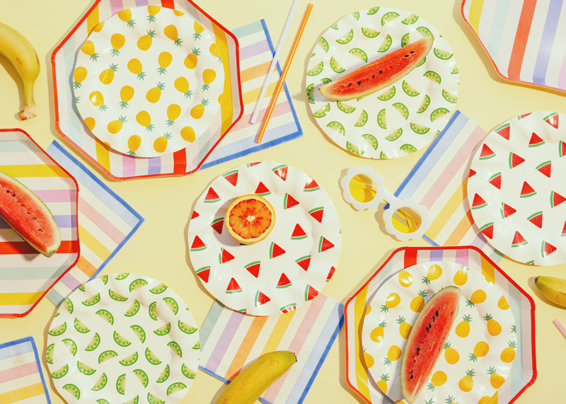 A summer picnic party setup with summer themed tableware and party supplies