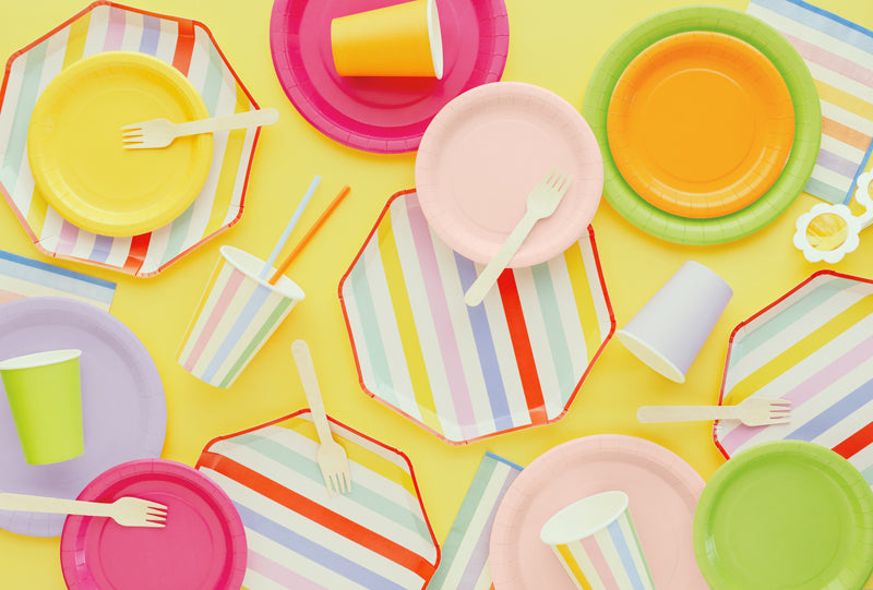 Summer Themed paper plates, cups, and utensils on a yellow background
