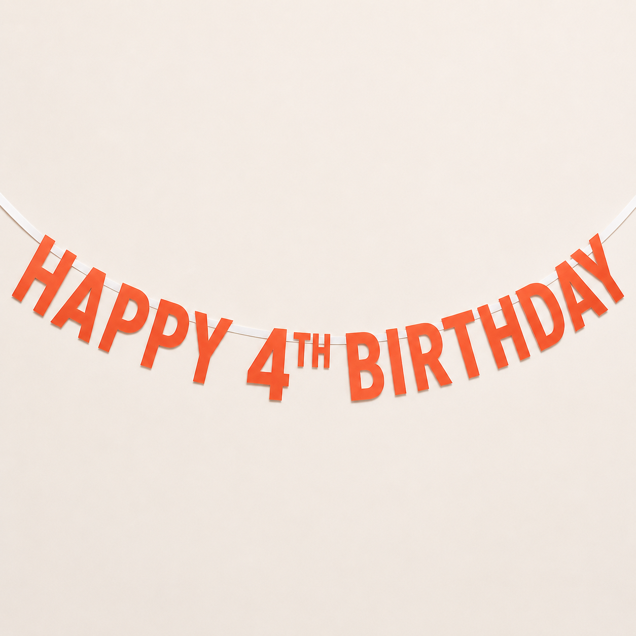 Orange 'HAPPY 4TH BIRTHDAY' banner letters strung along a white cord against a plain beige background.