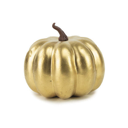 A small decorative pumpkin in a metallic gold finish with a dark brown stem, centered on a plain white background.