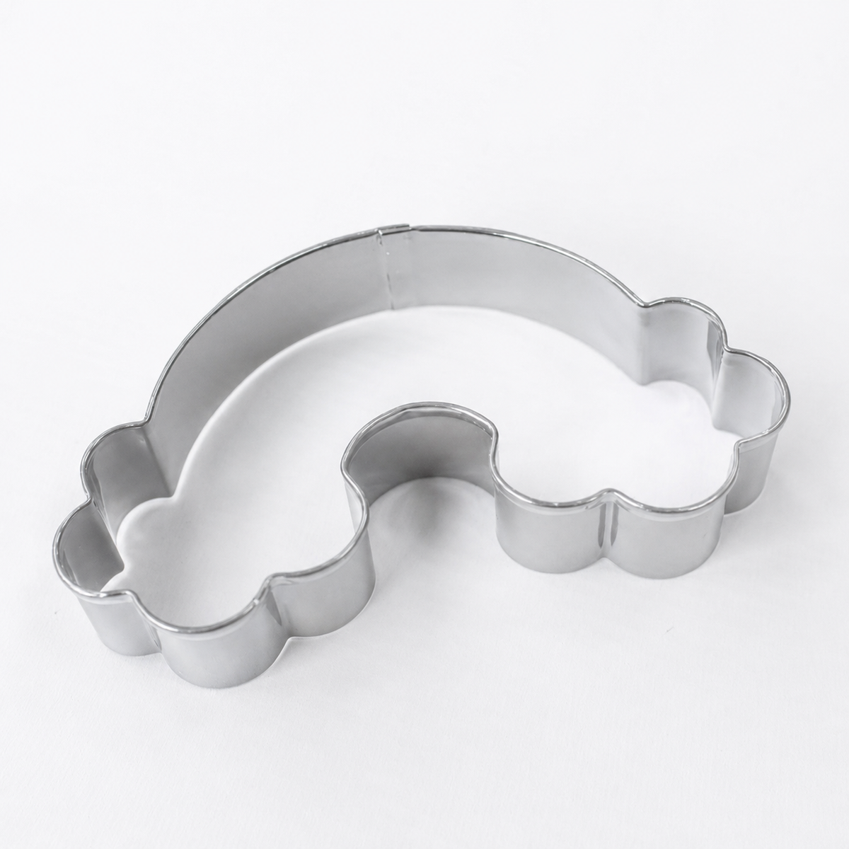 A silver metal rainbow-shaped cookie cutter on a plain white background.