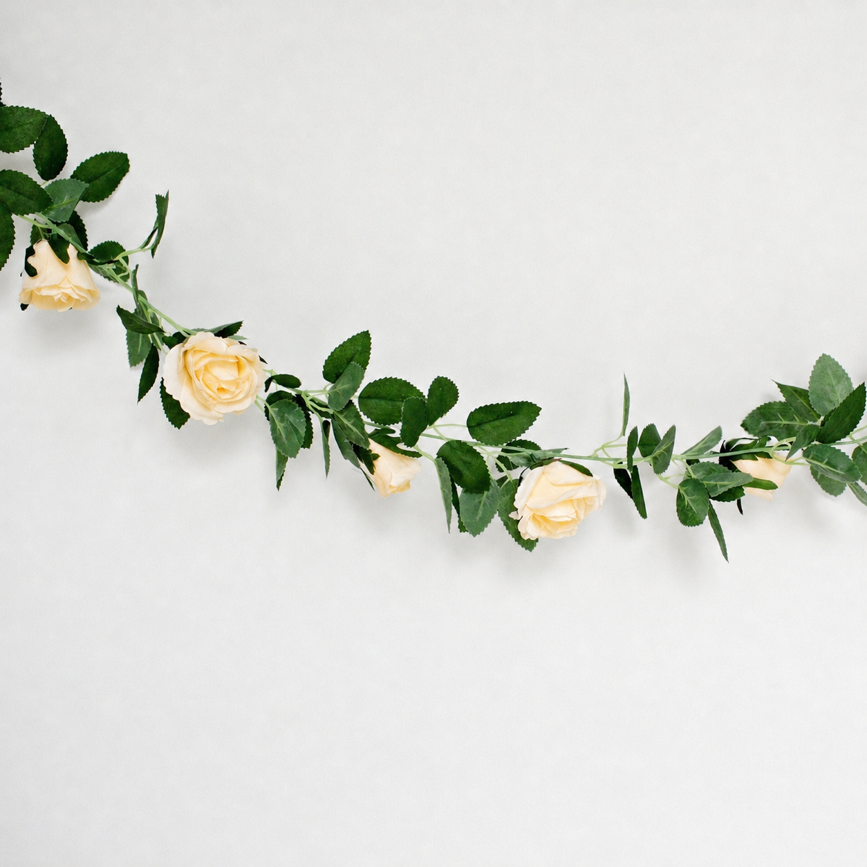 Faux Floral garland with champagne yellow flowers and green leaves