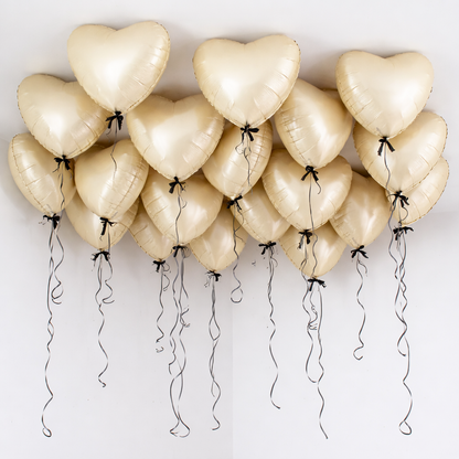 Heart-shaped balloons with bows and ribbons on a white background