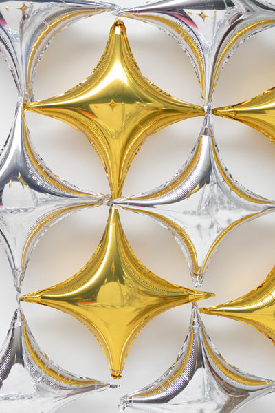 Silver and gold four point star balloons