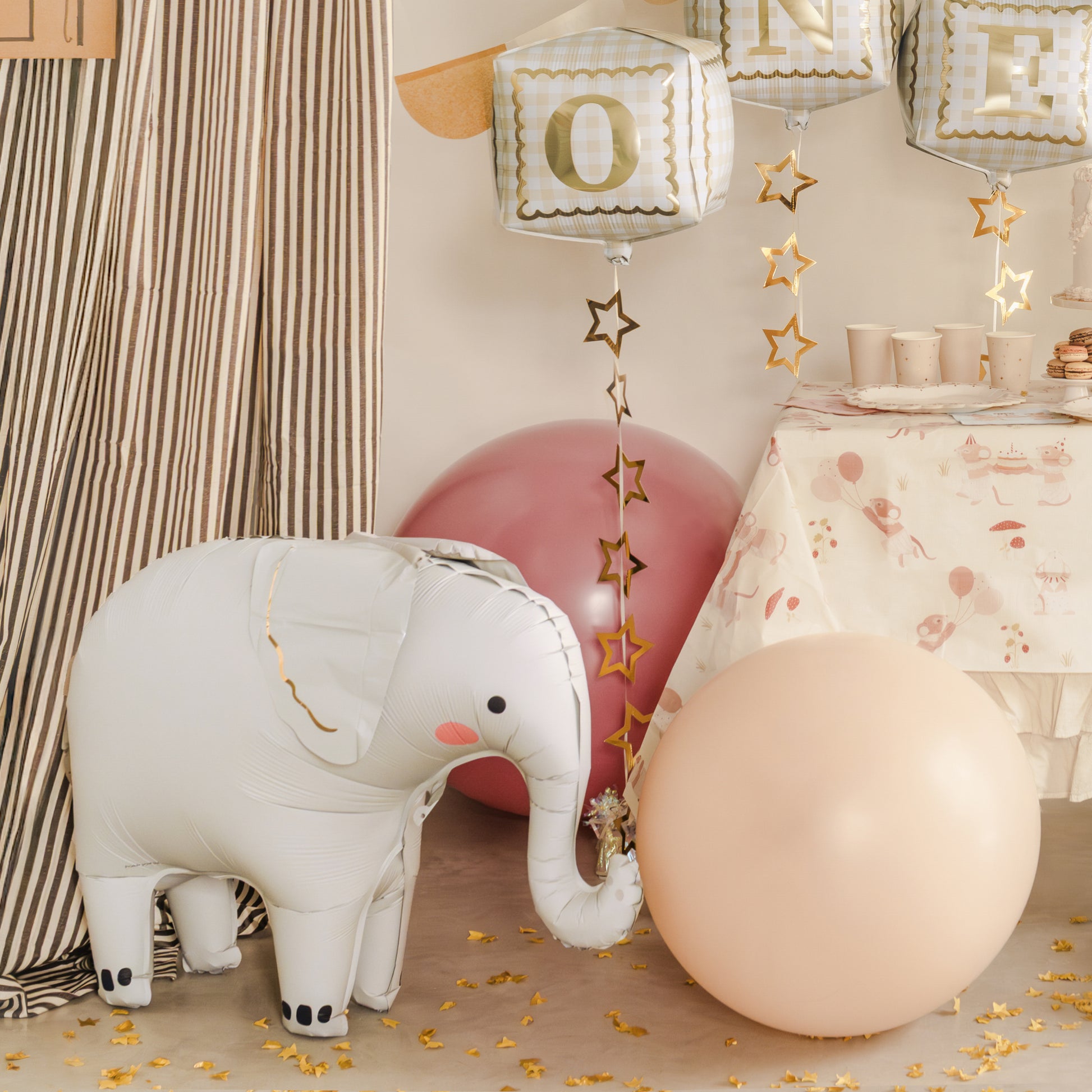 Standing elephant foil balloon with pink cheeks and grey body for jungle themed parties