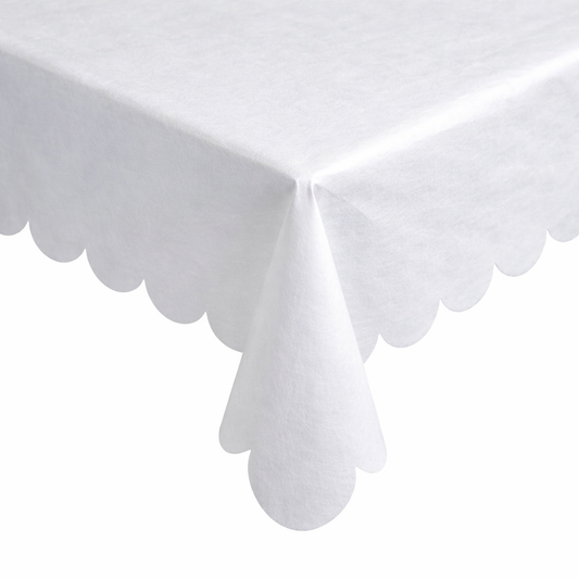White scalloped tablecloth on a white background