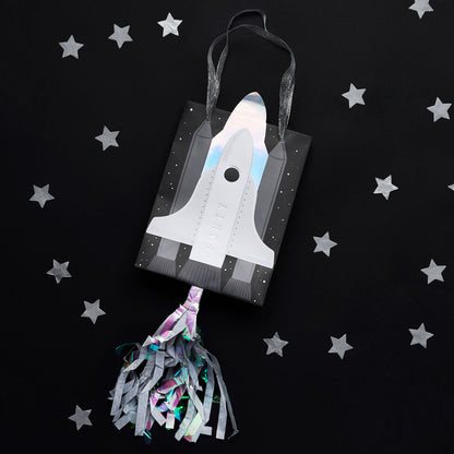 Luxury space themed party bags with rocket embellishments, ribbon handles and colourful streamers