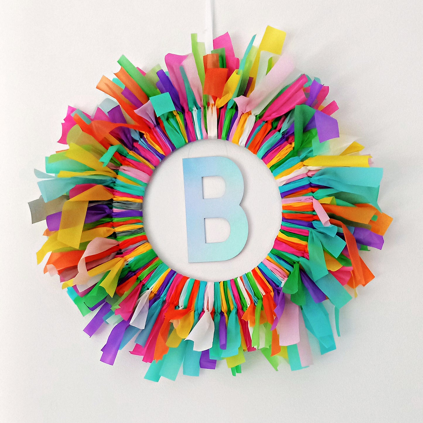 Colorful Birthday wreath with a letter 'B' in the center on a white background