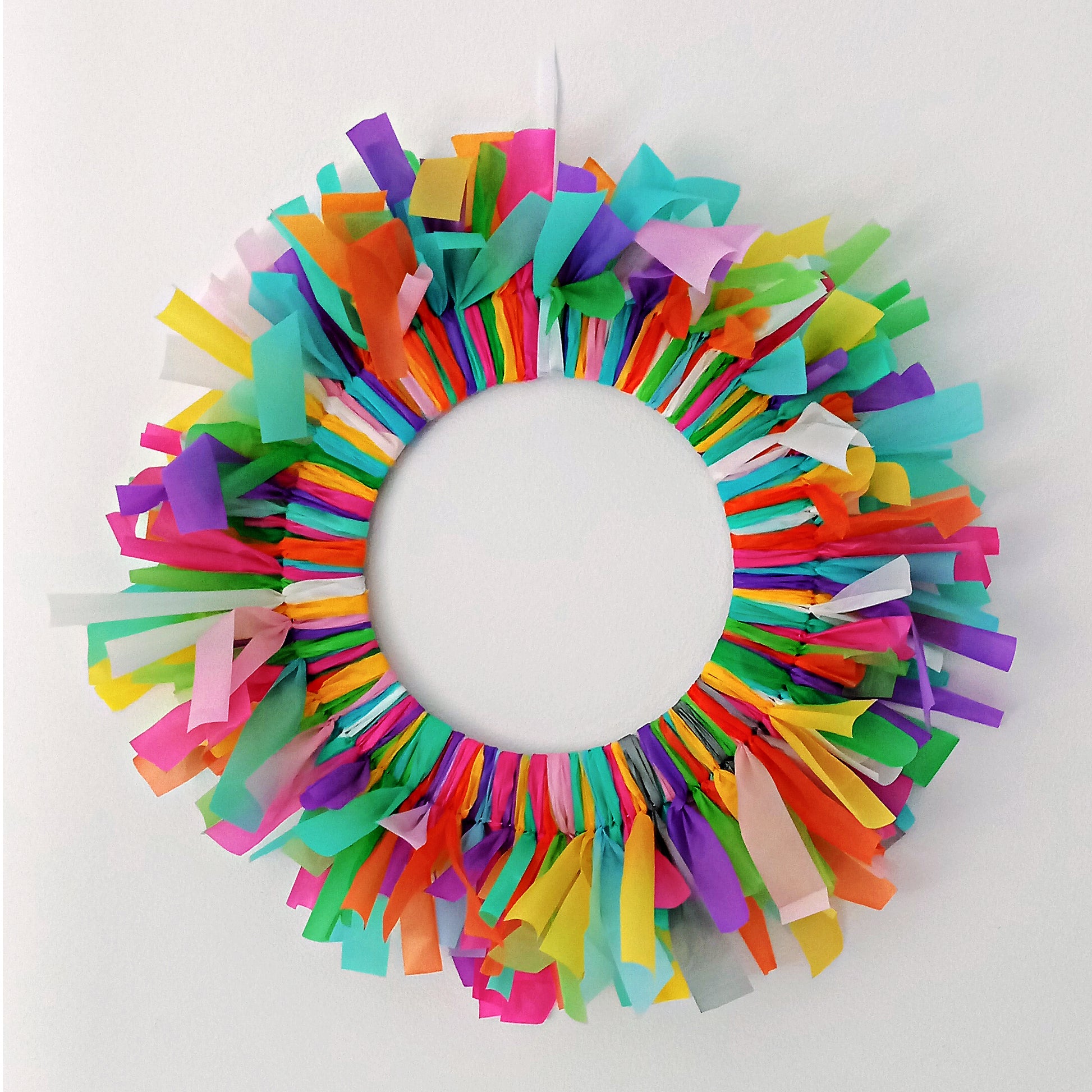 Colourful reusable birthday door decoration made from streamer off-cuts, circular wreath style.