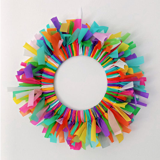 Colourful reusable birthday door decoration made from streamer off-cuts, circular wreath style.